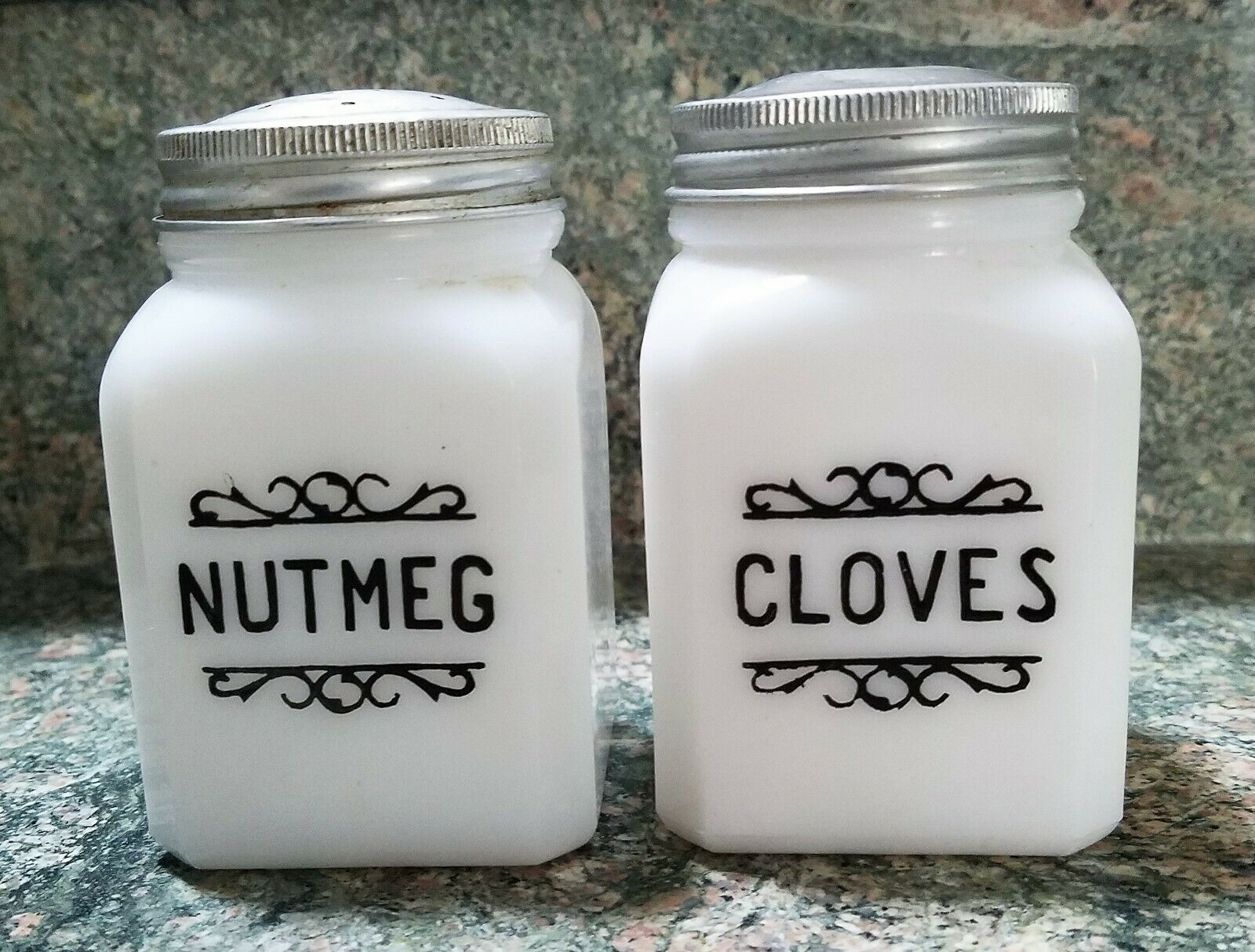 Antique Milk White Nutmeg & Cloves Leaf Shakers Original Lids, Black Letters